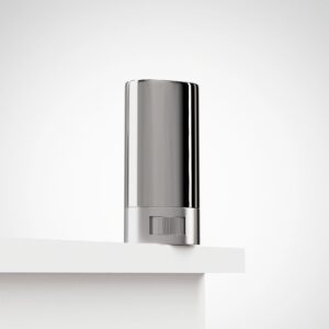 Compact metal one-hitter with small storage tube (dugout) on a neutral background